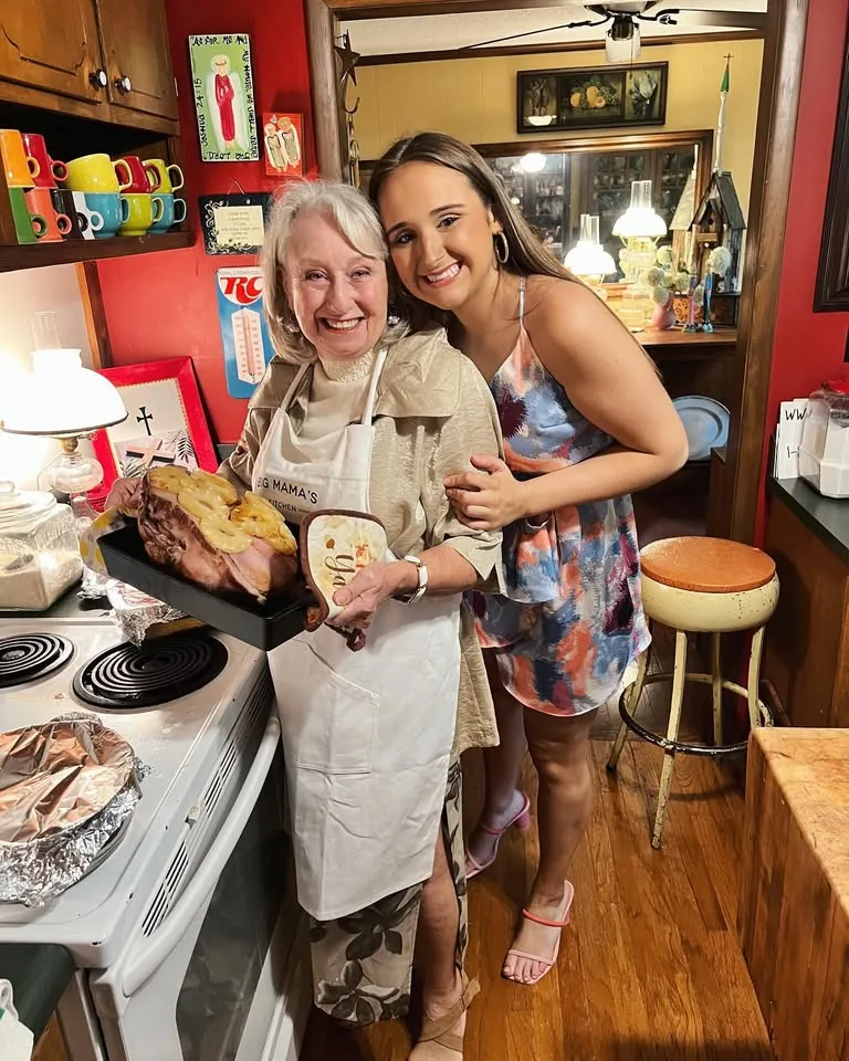 Two people sharing a light moment in a working kitchen