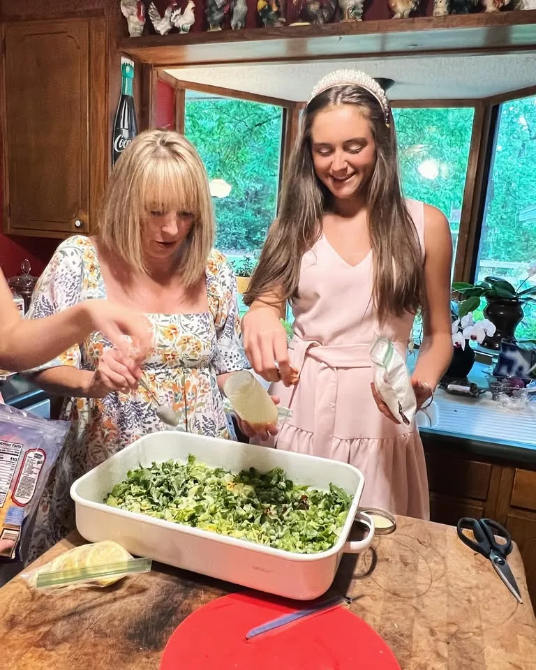 People preparing food together in a home kitchen